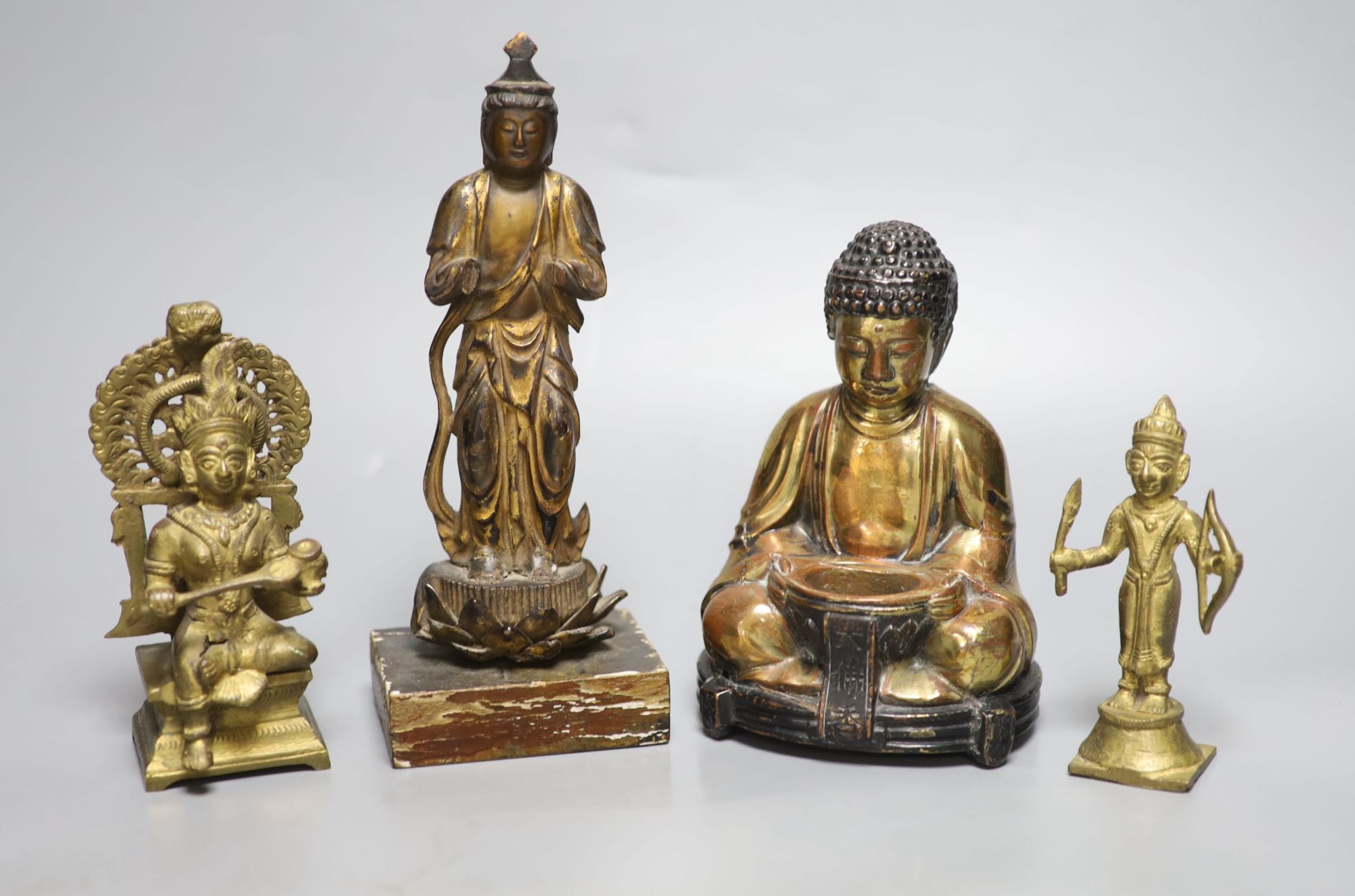 A Japanese gilt lacquered standing Buddha, a gilt copper Buddha and two Indian figures, tallest 21cm